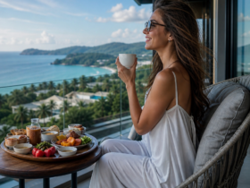 Woman enjoying breakfast on a balcony with a scenic ocean view in Thailand