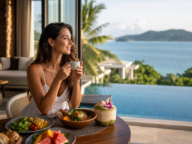 Woman eating a healthy breakfast by a pool overlooking the ocean in Thailand