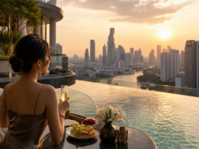 Woman with champagne relaxing in an infinity pool at sunset, overlooking a city skyline